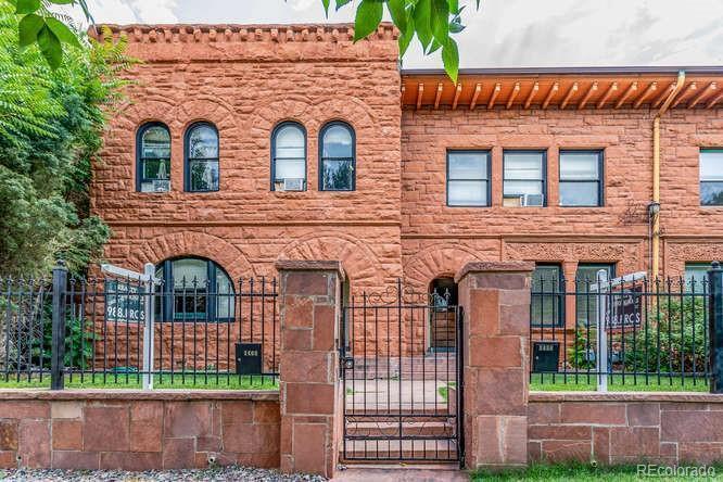Classic Denver Cap Hill historic facade with a cozy frontyard watered by sprinklers in the summer. - 1456 Pennsylvania St
