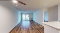 This contemporary 600 square foot apartment in Newport Beach offers a well-designed living space with two bedrooms and one bathroom. The open-concept layout maximizes the use of space, creating a seamless flow between the living room and kitchen. The kitchen features clean white cabinetry, stainless steel appliances, and a functional island with a sink, providing both preparation space and casual dining options.

Throughout the apartment, warm hardwood floors create a cohesive look and add a touch of elegance. Large windows in the living area and bedrooms allow ample natural light to flood the space, enhancing the bright and airy atmosphere. The primary bedroom, measuring 150 square feet, offers a generous space for relaxation.

The bathroom showcases a modern design with a large vanity, ample storage, and a clean white color scheme. A mirrored closet in the hallway provides additional storage space while visually expanding the area. The apartment also includes a balcony, perfect for enjoying outdoor views or fresh air.

Energy-efficient features such as recessed lighting and a wall-mounted air conditioning unit contribute to the apartment's modern appeal. The neutral color palette throughout allows for easy personalization, making this space an ideal canvas for various decorating styles. Located in the desirable Eight 80 Newport Beach complex, this apartment combines comfort, style, and convenience in a prime coastal location.