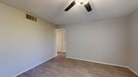 Located at 615 S Hardy Dr in Tempe, Arizona, this one-bedroom, one-bathroom unit offers a well-organized single-floor layout encompassing a kitchen, living room, bedroom, bathroom, closet, and hallway. Light wood-style flooring runs consistently throughout the space, lending a clean and cohesive feel.

The living room features a ceiling fan with light fixture, a textured ceiling, and painted brick accent walls that add architectural character. A large window with horizontal blinds allows natural light to fill the room, and a front entry door provides direct access.

The kitchen is outfitted with white shaker-style cabinetry, a white subway tile backsplash, light countertops, and a full suite of stainless steel appliances including a refrigerator, electric range, microwave, and dishwasher. Natural light enters through a window fitted with blinds.

The bedroom is a comfortable size, featuring a ceiling fan, a textured ceiling, large windows with outdoor views, and access to a dedicated closet with bifold doors. A hallway connects the main living areas to the private spaces.

The bathroom includes a tub/shower combination, a modern wood-toned vanity with a white countertop and integrated sink, and wood-style tile flooring, completing this efficiently designed unit.