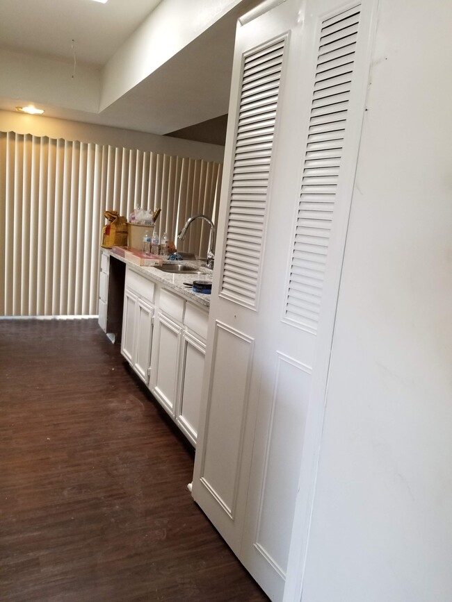 Coming in from the garage. Pantry cabinets to the right. - 5570 Aspen Valley St