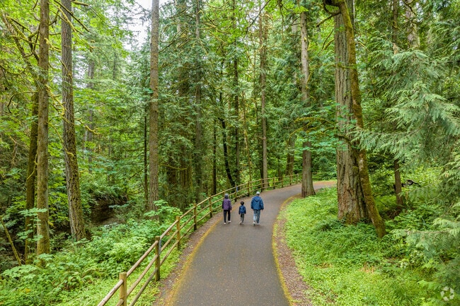 Residents enjoy a paved walking path in Hidden Falls Nature Park.
