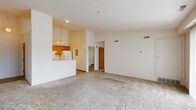 Located at 524 Sandpiper Ln in Wadsworth, Ohio, this single-floor, one-bedroom, one-bathroom unit offers a well-organized and efficiently designed layout. The entrance opens into a bright, open living area carpeted in neutral tones and bathed in natural light through large sliding glass doors that lead to an outdoor view — a standout feature of the space. The textured ceilings and clean white walls create a simple, airy ambiance throughout.

The galley-style kitchen is positioned adjacent to the living area and features warm oak cabinetry, light countertops, tile flooring, a white electric range, refrigerator, and a pendant chandelier overhead, adding a touch of character to the space.

The bedroom is a comfortable, well-proportioned room enhanced by a ceiling fan, a natural light-filled window with a wooded view, and direct access to a generously sized walk-in closet equipped with wire shelving on multiple walls for ample storage.

The full bathroom includes a tub-shower combination, a wood-toned vanity with a large mirror, tile flooring, and a stacked washer and dryer unit — providing the convenience of in-unit laundry. Overall, this unit delivers a clean, functional, and well-lit living environment in a quiet Wadsworth location.