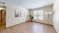 Located at 6755 Brandon Village Way in Canal Winchester, Ohio, this 2-bedroom, 1-bathroom single-floor residence offers a practical and comfortable layout designed to maximize its well-utilized footprint. Light wood-style flooring runs throughout the home, complemented by warm neutral walls and wood-trimmed baseboards that create a cohesive, inviting aesthetic.

The combined dining, kitchen, and living area forms the heart of the home. The living room receives generous natural light through a large window and features a textured ceiling. The galley-style kitchen is equipped with warm wood cabinetry extending to the ceiling, white appliances including a range and refrigerator, ample counter space, and a double sink — providing a highly functional cooking environment.

Both bedrooms are comfortably sized, each with natural window light, closet access, and the same wood-style flooring. The primary bedroom offers notably generous proportions. With four closets total throughout the home, storage is abundant.

The full bathroom includes a vanity with wood cabinetry, a large mirror, and a shower-tub combination. Additional utility is provided by a dedicated laundry area and utility room. A connecting hallway ties the layout together efficiently, making this a well-organized and move-in-ready home.