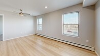 This contemporary 840 square foot apartment in Cedar Rapids, Iowa, offers a harmonious blend of comfort and functionality. The space features two bedrooms, including a primary bedroom of 130 square feet, and one bathroom. The open-concept design seamlessly integrates the kitchen and living area, creating a spacious feel.

The kitchen is a standout feature, boasting honey-toned wooden cabinetry, black appliances, and a practical island with a dark countertop. Light wood-look flooring in the kitchen and living area adds warmth and continuity to the space. Recessed lighting throughout ensures ample illumination.

Both bedrooms are carpeted for comfort and feature large windows that flood the rooms with natural light. Ceiling fans in the bedrooms provide additional comfort and air circulation. The bathroom is thoughtfully designed with accessibility in mind, featuring multiple grab bars, a spacious vanity, and ample storage.

Large windows in every room not only brighten the space but also offer views of the surrounding area. The apartment's neutral color palette, predominantly in soft greys and whites, creates a calm and versatile backdrop for personal decor.

Additional features include baseboard heating for winter comfort and a convenient in-unit closet for storage. The apartment's layout is efficient, with a hallway connecting the various spaces. Overall, this apartment offers a modern, comfortable living space with attention to both style and practicality.