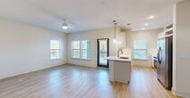 Located at 3280 Champion Ring Rd in Fort Myers, FL, this well-designed 3-bedroom, 2-bathroom residence offers a comfortable and modern living environment across a single floor. Light wood-style flooring flows consistently throughout, creating a cohesive and airy feel.

The open-concept living and dining area is anchored by large windows and a glass-paneled entry door that bathe the space in natural light. A ceiling fan enhances comfort, while views of the surrounding greenery add a pleasant outdoor connection. The kitchen is efficiently laid out in a galley style, featuring white cabinetry, white quartz countertops, a stylish tile backsplash, stainless steel appliances, and a peninsula with pendant lighting that opens toward the dining area.

Each of the three bedrooms is well-proportioned, with ceiling fans and windows that bring in natural light. The generously sized primary bedroom includes its own closet space. With seven closets total throughout the unit, storage is abundant. The two bathrooms are cleanly finished with white vanities accented by gold hardware and wood-style flooring. A dedicated laundry area and a connecting hallway complete the functional layout, making this a practical and attractive residence in Fort Myers.