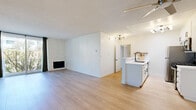Located at 10838 Rose Avenue in the heart of Los Angeles, this 2-bedroom, 2-bathroom unit offers a well-designed single-floor layout with a clean, modern aesthetic throughout. Light wood flooring runs continuously across all living areas, creating a cohesive and bright feel.

The open kitchen and living room area serves as the central hub of the unit. The kitchen features white shaker-style cabinetry with black hardware, white quartz countertops, a peninsula with a matte black faucet and undermount sink, and a full suite of stainless steel appliances including a gas range, over-the-range microwave, refrigerator, and dishwasher. A skylight overhead adds natural light to the space. The adjacent living room is generously sized and includes a fireplace, a sliding glass door leading to a balcony with outdoor views, and a textured accent wall.

Both bedrooms are well-proportioned, with the primary bedroom offering a comfortable footprint, large windows with natural light, and wall-unit climate control. The second bedroom similarly benefits from good natural light and ample space. The two bathrooms are finished in a clean, minimal style, with one featuring a glass-enclosed shower with white tile surround and black fixtures. A dedicated closet and hallway complete the functional layout of this well-appointed Los Angeles residence.