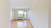 Located in the heart of Toronto's sought-after Annex neighbourhood, this one-bedroom, one-bathroom unit on St George Street offers a well-organized and functional layout across a single floor. Warm parquet flooring flows consistently throughout the living room and bedroom, lending a classic character to the space.

The living room is bright and airy, benefiting from a large window and a glass door that opens onto a private balcony with views of the surrounding treetops and neighbouring buildings. A radiator unit beneath the window provides in-unit heating. The bedroom is a comfortable size, complete with a dedicated closet featuring built-in shelving and a window that frames pleasant city and greenery views.

The kitchen is efficiently designed with white cabinetry, a tile backsplash, laminate countertops, a stainless steel sink, and a white electric range. The bathroom is finished with full-height beige tile surrounding a soaking tub with an overhead shower, complemented by a vanity with under-cabinet storage and a mirrored medicine cabinet. A hallway connects all rooms, adding a sense of separation and privacy throughout the unit.