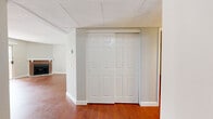 Located at 1171 Allen Ave in Glendale, California, this 2-bedroom, 2-bathroom residence offers a well-designed single-floor layout that balances comfort and functionality. Rich, warm-toned hardwood flooring flows throughout the living areas and bedrooms, creating a cohesive and inviting atmosphere.

The living room is a standout space, anchored by a classic brick fireplace with a white mantle and flanked by large windows and a sliding glass door that opens to a private balcony with views of mature trees. Natural light fills the room, enhancing its open, airy feel. The adjacent dining area connects seamlessly to the kitchen, which features white cabinetry, granite-style countertops, a gas range, and tile flooring — a practical and clean workspace.

Both bedrooms are generously proportioned, with the primary bedroom offering ample room and access to a dedicated closet with built-in shelving and hanging rods. The second bedroom is bright, with a large grid-pane window framing lush greenery outside. Two bathrooms serve the residence, including one with a sliding glass shower enclosure, tile floors, and a marble-topped vanity.

Two hallways connect the living spaces to the private quarters, and textured ceilings are present throughout. The layout is efficient and thoughtfully organized, making it a comfortable home in a well-located Glendale neighborhood.