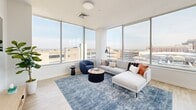 Located in the heart of Allentown, PA, this thoughtfully designed one-bedroom, one-bathroom residence offers a bright and contemporary living experience across a well-organized single floor. The open layout maximizes every square foot, with light wood flooring and crisp white walls creating a clean, modern aesthetic throughout.

The living room is a standout space, wrapped in expansive floor-to-ceiling windows on two sides that flood the room with natural light and frame sweeping views of the Allentown skyline. The kitchen is equally impressive, featuring white shaker cabinetry extending to the ceiling, white quartz countertops, subway tile backsplash, and a full suite of stainless steel appliances — all complemented by a large window overlooking the cityscape.

The generously sized primary bedroom continues the floor-to-ceiling window theme, offering abundant natural light and panoramic urban views. The room also provides access to a walk-in closet. The bathroom is finished in clean whites with brushed nickel fixtures, a soaking tub, and shaker-style cabinetry for ample storage.

A dedicated office nook with a window and floating shelves adds valuable functionality. This residence combines modern urban design with practical, comfortable living in downtown Allentown.