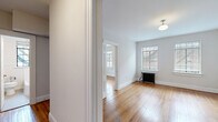 Located at 817 Hillsborough St in Raleigh, NC, this two-bedroom, one-bathroom unit blends classic architectural character with functional living. Warm hardwood floors extend throughout the entire space, lending continuity and timeless appeal to every room. The layout is efficiently organized across a single floor, connected by two hallways that provide smooth flow between spaces.

The spacious primary bedroom is a standout feature, offering generous proportions, multiple windows with natural light, and a classic cast-iron radiator that adds vintage charm. A built-in closet with a hanging rod provides practical storage. The second bedroom is a cozy, well-proportioned room with its own closet and the same rich hardwood flooring.

The galley-style kitchen is thoughtfully equipped with white cabinetry, granite countertops, stainless steel appliances including a full-size refrigerator, and open wood shelving that adds a contemporary touch. The bathroom features clean white tile surrounds, a full soaking tub, and a window that brings in natural light.

Throughout the unit, bright white walls, crisp white trim, and classic millwork details contribute to a clean, light-filled ambiance. The combination of period details like the cast-iron radiators and updated finishes in the kitchen and bath make this a well-balanced and characterful space.