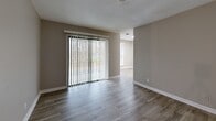 Located at 102 Brentway Cir in Knoxville, Tennessee, this single-floor, 2-bedroom, 2-bathroom residence offers a clean, modern aesthetic throughout. Wood-look plank flooring flows consistently across the space, complemented by neutral gray-toned walls and crisp white trim, creating a cohesive and contemporary feel.

The living room is bright and open, featuring a sliding glass door with vertical blinds that invite natural light and provide outdoor views. The combined kitchen and dining area is well-equipped with stainless steel appliances, granite-style countertops, white cabinetry, and a skylight overhead that further brightens the space. A pantry provides convenient additional storage.

Both bedrooms are comfortably sized, each outfitted with ceiling fans and closets featuring louvered bi-fold doors. The spacious primary bedroom includes a generous closet and natural light from a window. The two bathrooms feature granite-topped vanities with mirrors, maintaining the consistent modern finishes found throughout the home.

A central hallway connects the rooms efficiently, with four closets distributed throughout for ample storage. The utility room houses an in-unit washer, and a dedicated entrance completes the layout. This residence offers practical, move-in-ready living with thoughtful details throughout.