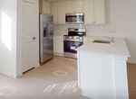 This two-story residence in Montgomery, TX offers 1830 square feet of living space, thoughtfully distributed across five bedrooms and two bathrooms. The ground floor spans 770 square feet, while the upper level provides a generous 1060 square feet.

The heart of the home is a contemporary kitchen, showcasing sleek white cabinetry, stainless steel appliances, and a practical island with a built-in sink. The kitchen opens to a light-filled living area, creating an ideal space for both daily living and entertaining.

Each of the five bedrooms is characterized by neutral tones, with some featuring plush carpeting and others boasting wood-look flooring. The primary bedroom is particularly spacious at 200 square feet. Large windows in the bedrooms allow for ample natural light and offer views of the surrounding area.

The bathrooms are designed with modern aesthetics and functionality in mind, featuring clean lines, white fixtures, and a combination of tile and wood-look flooring. One bathroom includes a shower/tub combo with built-in shelving for added convenience.

Throughout the home, recessed lighting and ceiling fans contribute to a bright, airy atmosphere. The neutral color palette and minimalist design create a blank canvas for personalization. Three closets provide additional storage space, while a staircase connects the two floors. The property's layout, as seen in the 3D floor plan, shows a well-organized and efficient use of space, making this home both comfortable and practical for modern living.