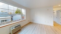 Located at 1323 SW Cherry Park Rd in Troutdale, Oregon, this single-floor, 2-bedroom, 1-bathroom home offers a thoughtfully designed layout with a clean, modern aesthetic. Light wood-tone flooring flows consistently throughout, complementing the crisp white walls and creating a bright, cohesive feel across every room.

The open-concept living, dining, and kitchen area forms the heart of the home. The kitchen is well-appointed with light maple cabinetry, white countertops, stainless steel appliances including a range and refrigerator, and a deep stainless steel sink. A pantry provides additional storage convenience.

The living area is generously proportioned, featuring a large picture window that floods the space with natural light and offers views of the surrounding neighborhood. The primary bedroom is a comfortable size, featuring a double closet with classic panel doors and recessed lighting. The second bedroom also benefits from multiple windows, bringing in ample natural light and outdoor views of the greenery beyond.

The bathroom is clean and functional, finished in white with a glass-door shower/tub combination, grab bars, and a vanity. Three closets throughout the home offer practical storage solutions. The overall ambiance is fresh and move-in ready, reflecting a modern, minimalist sensibility well-suited to comfortable everyday living.