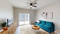 Located at 3861 W University St in Springfield, MO, this one-bedroom, one-bathroom unit offers a thoughtfully designed open-concept layout. The living room is bright and welcoming, featuring light wood-style flooring, a ceiling fan, and a sliding glass door that fills the space with natural light and provides outdoor access. The kitchen flows seamlessly into the living area and is appointed with rich dark wood cabinetry, granite countertops, a peninsula with bar seating, a stainless steel undermount sink, and a full suite of stainless steel appliances — including a refrigerator, range, and microwave. Recessed lighting throughout the kitchen and living area enhances the modern aesthetic. The bedroom is a comfortable retreat with plush carpeting, a ceiling fan, a natural light window, and direct access to a dedicated closet, offering practical storage. The bathroom continues the consistent design language with a granite-topped vanity, dark wood cabinetry, wood-style tile flooring, and a full soaking tub. Neutral tones and clean finishes throughout the unit create a cohesive, contemporary atmosphere well-suited for comfortable everyday living.