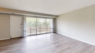 Located at 14801 Bowie Rd in Laurel, MD, this well-appointed 2-bedroom, 1-bathroom residence offers a thoughtfully designed single-floor layout. The combined living and dining area is a standout feature, bathed in natural light through a large sliding glass door that opens onto a private balcony overlooking lush, mature trees — creating a serene, nature-connected atmosphere. The living space is finished with light hardwood-style flooring that extends throughout the main areas, lending a clean and modern feel.

The kitchen is efficiently arranged with crisp white shaker-style cabinetry, granite-look countertops, a stainless steel sink, and a full suite of stainless steel appliances including a gas range, dishwasher, and refrigerator. Tile wainscoting adds a practical and polished touch along the kitchen walls.

Both bedrooms feature plush wall-to-wall carpeting in neutral tones. The primary bedroom is generously sized with dual windows that invite ample natural light and offer pleasant outdoor views. The second bedroom also features carpeting and direct hallway access. Three closets throughout the unit provide excellent storage. The bathroom is finished with tile surround, a white vanity with under-cabinet storage, and a mirror with overhead lighting. A hallway connects all rooms cohesively throughout this comfortable and functional residence.