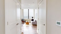 Located at 112 Market St in downtown Harrisburg, PA, this well-appointed 2-bedroom, 2-bathroom residence offers a thoughtfully designed layout across a single floor. The open-concept living, dining, and kitchen area serves as the heart of the home, bathed in natural light from expansive floor-to-ceiling windows that frame sweeping views of the city and surrounding landscape. The living room features warm hardwood-style flooring and generous proportions, ideal for both relaxing and entertaining.

The kitchen is outfitted with stainless steel GE appliances, including a side-by-side refrigerator with water and ice dispenser, an electric range, and an over-the-range microwave. Crisp white shaker cabinetry, dark granite countertops, and a hexagonal tile backsplash give the space a clean, modern aesthetic.

Both bedrooms are carpeted and tranquil, with the primary bedroom offering a spacious, comfortable retreat, while the second bedroom also benefits from abundant natural light and closet access. The two bathrooms include hardwood-style flooring, walk-in showers, and white vanities. Additional features include a dedicated laundry area, four closets, and a connecting hallway that ties the layout together seamlessly.