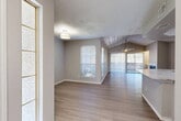Located at 600 Legacy Dr in Plano, TX, this single-story, 3-bedroom, 3-bathroom home offers a well-designed layout with modern finishes throughout. The open living and dining area is a standout feature, showcasing vaulted ceilings with wood paneling, a ceiling fan, and light-toned wood-look flooring that extends across the main living spaces. Large windows and a sliding glass door fill the area with natural light and provide direct access to an outdoor patio. The kitchen is outfitted with white shaker-style cabinetry, marble-look countertops, a tile backsplash, and a full suite of stainless steel appliances. The bedrooms offer a comfortable, quiet retreat — the primary bedroom is generously sized and features plush carpeting, while additional bedrooms include wood-look flooring and ample natural light. Each of the three bathrooms is finished with white vanity cabinetry, marble-look countertops, and gold-tone hardware accents. The bathrooms also include tub/shower combinations with clean white surrounds. Multiple closets throughout the home, including a walk-in with wire shelving, provide excellent storage. Hallways are bright and cleanly finished, connecting the home's spaces with ease. A dedicated laundry area adds everyday convenience to this move-in-ready residence.