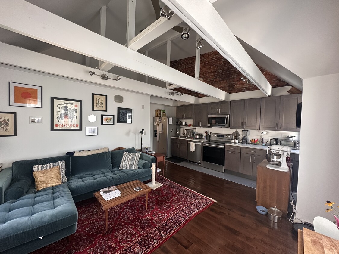 Living & Kitchen area with loft ceiling and exposed brick - 4818-3 Baltimore Ave