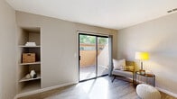 Located at 6430 Verner Avenue in Sacramento, CA, this one-bedroom, one-bathroom unit offers a thoughtfully designed single-floor layout that maximizes functionality and comfort. The living room is bright and inviting, featuring light wood-style laminate flooring and a large sliding glass door that opens to a private patio, flooding the space with natural light and providing easy access to outdoor views. The open pass-through connects the living area seamlessly to the kitchen, which is well-equipped with white cabinetry, dark countertops, stainless steel appliances including a refrigerator, range, and microwave, and a double-basin sink — all set atop matching light wood-style flooring. The bedroom offers a cozy retreat with plush wall-to-wall carpeting, a natural light source through a window with vertical blinds, and a closet for ample storage. The full bathroom is clean and functional, featuring a combined tub and shower, a vanity with storage, and matching light flooring. Neutral warm-toned walls throughout the unit create a cohesive and calm aesthetic, making this a comfortable and move-in-ready space in the Sacramento area.