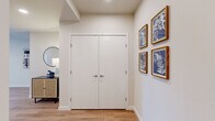Located in Everett, WA, this well-appointed two-bedroom, two-bathroom residence offers a thoughtfully designed single-floor layout with a clean, modern aesthetic throughout. Light hardwood flooring flows continuously across the space, complementing the neutral white walls and creating a warm, cohesive feel.

The open-concept living and dining area is a standout feature, bathed in abundant natural light from a generous bank of large windows that frame sweeping city and treetop views. The space comfortably accommodates both a dining set and a living area, making it ideal for both relaxing and entertaining.

The kitchen is outfitted with wood-toned cabinetry extending to the ceiling, white quartz countertops, and a full suite of stainless steel appliances including a refrigerator, range, microwave, and dishwasher — offering both style and functionality.

Both bedrooms are well-sized, each featuring large windows with urban views, hardwood flooring, and ample closet space with sliding doors. The primary bedroom benefits from an especially bright outlook over the city.

The two bathrooms are finished in a clean, contemporary style. One features a tiled shower-tub combo with chrome fixtures, while the second includes a glass-enclosed walk-in shower and a wood-accented vanity with a white countertop — each accented with light wood flooring for a cohesive look.