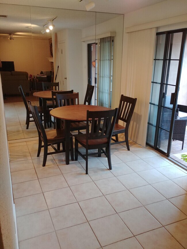 Across from the kitchen is the back porch, with seating and BBQ grill. - 2415 Idlewilde Dr
