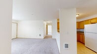 Located at 3045 Gehlar Rd NW in Salem, Oregon, this single-floor residence offers a practical and comfortable layout with two bedrooms and two full bathrooms. The open living room is generously proportioned, featuring soft wall-to-wall carpeting, neutral tones, and large windows fitted with blinds that invite abundant natural light. A ceiling fan adds comfort and airflow to the space.

The kitchen is well-equipped with warm honey-toned cabinetry offering ample storage, a full suite of white appliances including a refrigerator, electric range, and over-the-range microwave, along with light tile flooring that transitions seamlessly from the carpeted living area.

The primary bedroom is a comfortable, well-lit room with carpeted flooring, a ceiling fan, and windows overlooking the surrounding neighborhood. It features a dedicated hallway with closet storage. The second bedroom mirrors the same clean aesthetic with carpeting and a bright window.

Both bathrooms are finished with warm wood-toned vanity cabinetry, tile flooring, and large mirrors. The full bath includes a tub-shower combination with sliding glass doors. Throughout the home, a consistent palette of neutral walls and warm wood trim creates a cohesive and welcoming atmosphere.