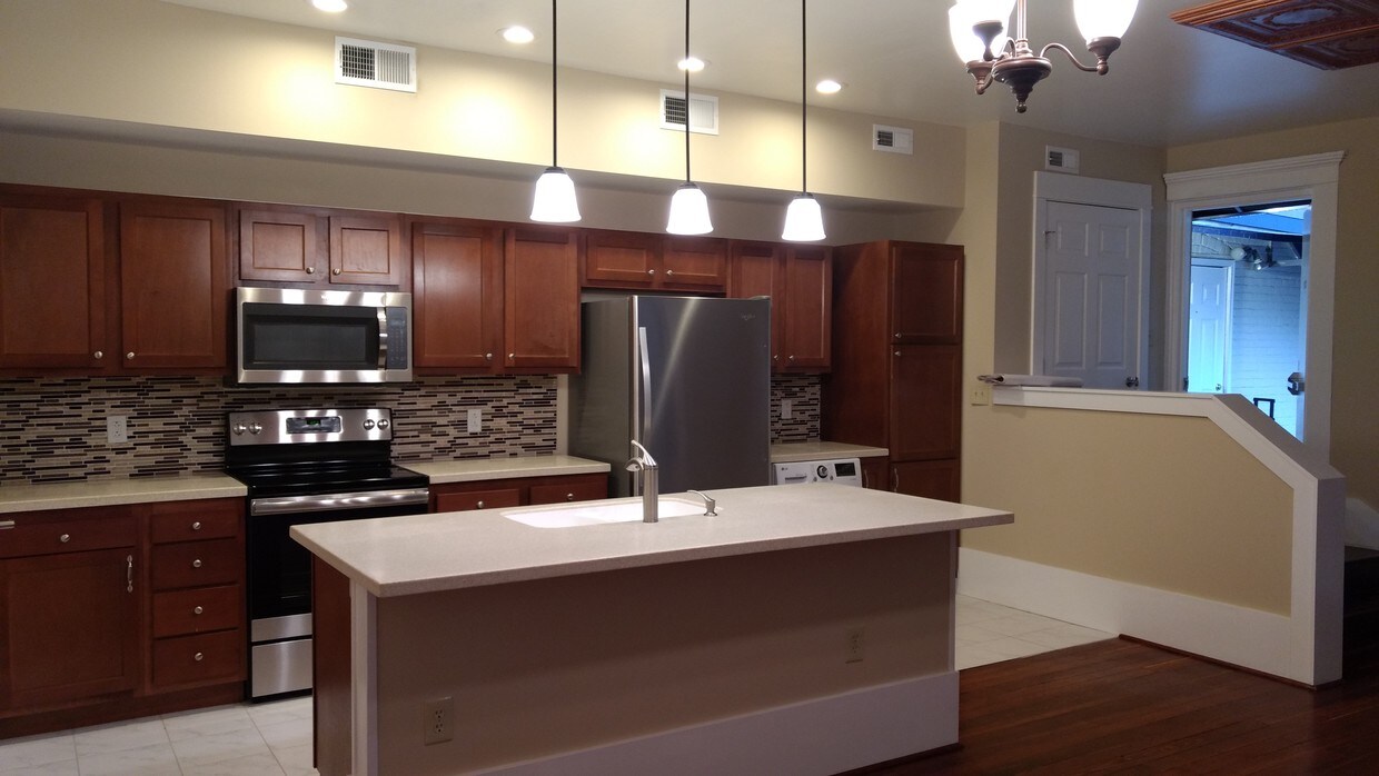 Kitchen featuring high-end stainless steel ap - 15 N State St