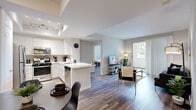 Located at 3770 S Figueroa in Los Angeles, CA, this well-appointed two-bedroom, two-bathroom residence is thoughtfully designed across a single floor. The open-concept layout seamlessly connects the kitchen, dining area, and living room, creating an inviting and functional shared space. The kitchen is fitted with crisp white shaker cabinetry, white quartz countertops, stainless steel appliances including a gas range, microwave, and refrigerator, and a peninsula that offers additional prep and seating space. A dedicated pantry provides generous storage. Wood-style flooring flows throughout the main living areas, lending warmth and visual continuity. The living room is bright and airy, benefiting from natural light and sliding door access to an outdoor area with greenery views. Both bathrooms feature tub-shower combinations with sliding glass doors, white vanities, and wood-style tile flooring. One bathroom includes a glass block window for added natural light. The spacious primary bedroom offers a comfortable retreat, while the second bedroom is well-suited for a guest room or home office. Six closets throughout the residence ensure ample storage. The overall ambiance is clean, modern, and light-filled, making it an ideal home in the heart of Los Angeles.