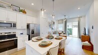 This 650 square foot, single-floor apartment in Charlotte, NC offers a harmonious blend of modern design and practical living. The open-concept layout maximizes the use of space, creating a seamless flow between the living area and kitchen. The living room is bathed in natural light from large windows and sliding glass doors, which also provide access to an outdoor area. Neutral tones dominate the interior, with pops of color from carefully chosen decor pieces.

The kitchen is a standout feature, boasting white cabinetry, stainless steel appliances, and a central island that doubles as a dining space. The bedroom, measuring 130 square feet, is well-appointed with ample natural light and storage solutions. The bathroom continues the modern aesthetic with a glass-enclosed shower and sleek fixtures.

Throughout the apartment, hardwood floors add warmth and continuity. The space is further enhanced by thoughtful details such as recessed lighting, a ceiling fan in the living area, and stylish light fixtures. A dedicated laundry area and closet space contribute to the apartment's functionality. The overall design creates an inviting, contemporary living space that maximizes comfort and style within its compact footprint.