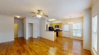 This single-story, 1-bedroom, 1-bathroom unit in Gonzales, Louisiana, offers a well-designed layout that maximizes comfort and functionality. The open-concept living and dining area is highlighted by rich, warm-toned hardwood flooring that extends throughout the main living spaces, complemented by ceiling fans with light fixtures and multiple windows that allow abundant natural light to fill the rooms. Crown molding adds a refined architectural detail throughout.

The kitchen is thoughtfully designed in a galley style, featuring light oak cabinetry, dark granite countertops, and a full suite of black appliances, including a refrigerator, electric range, built-in microwave, and dishwasher. A breakfast bar with a pass-through window connects the kitchen to the living area, enhancing the open flow of the space.

The bedroom offers a comfortable retreat with plush wall-to-wall carpeting, crown molding, a ceiling fan, and a window with an outdoor view. A closet provides convenient storage.

The bathroom is well-appointed with tile flooring, a granite-topped vanity with oak cabinetry, and a full soaking tub and shower combination. The unit also includes a walk-in closet accessible from the main living area, providing additional storage solutions.
