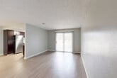 Located at 509 Evanston Ct in Aurora, Colorado, this one-bedroom, one-bathroom residence offers a well-organized single-floor layout designed for comfortable everyday living. Throughout the home, wood-look flooring provides a clean, cohesive aesthetic complemented by neutral gray walls and crisp white trim.

The living room is an open, airy space anchored by a sliding glass door with vertical blinds that invites natural light and provides outdoor access. A textured popcorn ceiling carries through much of the home, adding a classic residential feel. The kitchen is a standout feature, outfitted with rich dark espresso cabinetry, light quartz-style countertops, a mosaic tile backsplash, and stainless steel appliances including a refrigerator and range. A window above the counter brings in additional natural light.

The bedroom is a comfortable, well-proportioned retreat with a natural light window, wood-look flooring, and access to two closets, providing ample storage. The bathroom is neatly appointed with a tub and shower combination featuring marble-patterned tile surrounds, brushed nickel fixtures, and a built-in shower niche. The space is rounded out with practical details including visible HVAC vents and easy-care flooring throughout.