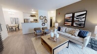 Located in Lockport, IL, this well-appointed single-floor residence offers a thoughtfully designed open-concept layout with contemporary finishes throughout. The living room serves as the heart of the home, featuring wood-look flooring, a neutral color palette accented by a warm taupe feature wall, and sliding glass doors that invite natural light and provide access to an outdoor patio area. A dedicated dining space adjacent to the living area is highlighted by a modern chandelier, offering an ideal setting for entertaining.

The kitchen is well-equipped with stainless steel appliances, including a gas range and built-in microwave, ample white cabinetry, and granite-style countertops that extend generously along both sides of the galley-style layout. Wood-look flooring continues seamlessly through this space.

Two comfortable bedrooms provide restful retreats, each featuring plush carpeting and large windows that allow abundant natural light. The primary bedroom includes a corner window arrangement, enhancing its bright, airy feel.

Both bathrooms are finished with white shaker-style cabinetry, granite countertops, and wood-look flooring. The primary bathroom features a window for added natural light, while the secondary bathroom offers a shower with curtain enclosure. Clean lines and neutral tones create a cohesive, modern ambiance throughout the entire residence.