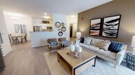 Located in Lockport, IL, this well-appointed single-floor residence offers a thoughtfully designed open-concept layout with contemporary finishes throughout. The living room serves as the heart of the home, featuring wood-look flooring, a neutral color palette accented by a warm taupe feature wall, and sliding glass doors that invite natural light and provide access to an outdoor patio area. A dedicated dining space adjacent to the living area is highlighted by a modern chandelier, offering an ideal setting for entertaining.

The kitchen is well-equipped with stainless steel appliances, including a gas range and built-in microwave, ample white cabinetry, and granite-style countertops that extend generously along both sides of the galley-style layout. Wood-look flooring continues seamlessly through this space.

Two comfortable bedrooms provide restful retreats, each featuring plush carpeting and large windows that allow abundant natural light. The primary bedroom includes a corner window arrangement, enhancing its bright, airy feel.

Both bathrooms are finished with white shaker-style cabinetry, granite countertops, and wood-look flooring. The primary bathroom features a window for added natural light, while the secondary bathroom offers a shower with curtain enclosure. Clean lines and neutral tones create a cohesive, modern ambiance throughout the entire residence.
