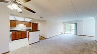 Located at 154 Juliann Dr in Wood Dale, Illinois, this 2-bedroom, 1-bathroom home offers a practical and comfortable single-floor layout. The open living room is spacious and bright, featuring wall-to-wall carpeting, a ceiling fan, and large sliding glass doors that lead to a private balcony overlooking a tranquil pond with a fountain and lush green surroundings — a standout feature of the property.

The kitchen is well-appointed with warm oak cabinetry, dark granite-style countertops, a center island with additional counter space, white appliances including a gas range, microwave, dishwasher, and refrigerator, and a drop ceiling with recessed panel lighting. The tile flooring adds practicality to the cooking space.

Both bedrooms are carpeted and filled with natural light from windows with outdoor views. The primary bedroom offers generous proportions and includes a closet with bifold doors. The second bedroom also features a window and a closet door, providing ample storage.

The full bathroom is clean and functional, featuring a tub/shower combo with white tile surround, a single vanity with wood cabinetry, and tile flooring. The neutral palette throughout the home creates a calm, move-in-ready atmosphere ideal for comfortable everyday living.