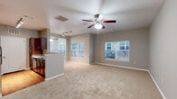 Located at 2728 Golden Currant View in Colorado Springs, Colorado, this single-floor residence offers a well-designed, open-concept layout that maximizes both functionality and comfort. The spacious living area is finished with plush wall-to-wall carpeting and features a ceiling fan with integrated lighting. Multiple windows allow generous natural light to fill the room, creating a bright and welcoming atmosphere. A seamlessly connected kitchen sits adjacent to the living space, distinguished by rich dark-wood cabinetry, granite countertops, and hardwood-style flooring. Track lighting illuminates the kitchen area, and a peninsula counter provides a practical transition between the kitchen and living room. The bedroom areas are generously proportioned, each featuring soft carpeting, ceiling fans, and windows that invite natural light. The bathroom is finished with matching dark-wood vanity cabinetry, granite countertops, hardwood-style flooring, and a well-lit vanity mirror. Throughout the residence, a consistent neutral color palette of warm greige tones ties the spaces together, contributing to a clean, cohesive aesthetic. White panel doors and crisp baseboards add refined detailing throughout the home.