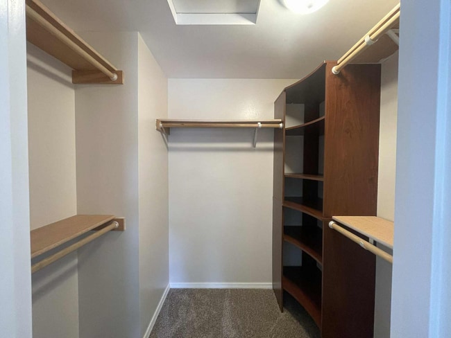 large walk-in closet with five separate shelves and built-in storage organizer - 245 S 126th St