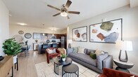 Located at 17700 E 64th Ave in Denver, CO, this single-floor, 2-bedroom, 2-bathroom home offers a thoughtfully designed open-concept layout. The living room is bright and welcoming, featuring large windows that invite natural light, light wood-style flooring, and a ceiling fan overhead. It flows seamlessly into the kitchen and dining area, creating an ideal space for everyday living and entertaining.

The kitchen is a standout feature, equipped with rich dark wood cabinetry, granite countertops, stainless steel appliances, and a central island with bar seating and pendant lighting above. The adjacent dining area provides additional space for meals and gatherings.

The primary bedroom is a generously sized retreat with plush carpeting, a ceiling fan, and its own dedicated closet. The second bedroom is equally comfortable, offering carpeted flooring and ample natural light from a large window. Both bathrooms are finished with granite-topped vanities, dark wood cabinetry, and tub-shower combinations.

Additional spaces include a utility room, hallway, and two closets, ensuring practical storage throughout. The home's neutral color palette, consistent finishes, and modern fixtures create a cohesive and polished aesthetic throughout every room.