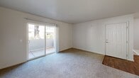 Located in Cameron Park, CA, this three-bedroom, one-bathroom unit offers a practical and well-organized single-floor layout. The spacious primary bedroom features plush carpeting, a sliding glass door opening to a private patio with outdoor views, and access to a generously sized walk-in closet complete with built-in shelving and hanging rods. The two additional bedrooms are also carpeted and filled with natural light from windows overlooking the surrounding greenery. The kitchen is equipped with white cabinetry trimmed in wood tones, a full suite of appliances including a range, refrigerator, and dishwasher, and durable hardwood-style flooring that extends through the main living areas and hallways. A dedicated laundry area provides washer and dryer hookups along with overhead shelving for added storage convenience. The full bathroom includes a shower-tub combination with chrome fixtures and hardwood-style flooring. Throughout the unit, neutral wall tones and clean lines create a bright, move-in-ready atmosphere. Sliding glass patio doors in multiple rooms allow for abundant natural light and easy outdoor access, enhancing the overall sense of openness within the home.