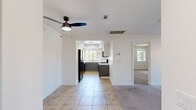Located at 69150 Gerald Ford Dr in Cathedral City, California, this well-appointed 2-bedroom, 2-bathroom residence offers a comfortable and functional single-floor layout. The living room serves as the heart of the home, featuring plush carpeting, a tile-surround fireplace, and a sliding glass door that opens to a private outdoor space, filling the room with natural light and outdoor views. Adjacent to the living area, the kitchen is thoughtfully designed with two-tone cabinetry — white upper cabinets paired with grey lower cabinets — white quartz countertops, a hexagonal tile backsplash, and black appliances including a gas range, microwave, dishwasher, and refrigerator. Tile flooring and a window overlooking greenery complete the kitchen's clean, modern aesthetic. The generously sized primary bedroom offers ample space, soft carpeting, and a dedicated walk-in closet. The second bedroom is equally comfortable, with plush carpeting, natural light from a window, and its own closet. Both bathrooms are finished with tile flooring, grey vanity cabinetry, and tub-shower combinations enclosed by sliding glass doors. Clean white walls and neutral tones throughout the residence create a bright and cohesive living environment.