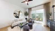 Located at 2120 E Ray Rd in Gilbert, AZ, this efficiently designed one-bedroom, one-bathroom home offers a thoughtful single-story layout that maximizes every square foot. The open-concept living and dining area is anchored by light wood-look flooring, crisp white walls, and a ceiling fan overhead. Large sliding glass doors flood the space with natural light and provide direct access to an outdoor patio, offering pleasant views of lush greenery. The kitchen is a standout feature, showcasing two-tone cabinetry with white upper cabinets and gray lower cabinets, white quartz countertops, stainless steel appliances, and a charming window above the sink that lets in additional natural light. A bar-height counter provides casual seating. The bedroom is a serene retreat, comfortably sized with large windows, soft neutral finishes, and access to a dedicated closet. The bathroom is clean and modern, featuring gray vanity cabinetry, white countertops, light wood-look flooring, and a frameless sliding glass shower enclosure. A hallway connects the rooms efficiently, completing the well-organized floor plan. The overall ambiance is bright, contemporary, and inviting throughout.
