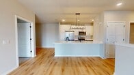 This contemporary 1480 square foot residence spans two floors, offering a harmonious blend of functionality and style. The ground floor, encompassing 480 square feet, houses essential living areas, while the upper level extends to 1000 square feet.

The home boasts two bedrooms, including a spacious primary bedroom of 170 square feet, and three full bathrooms. The kitchen is a highlight, featuring sleek white cabinetry, stainless steel appliances, and a modern island with a built-in sink. The living area seamlessly connects to the kitchen, creating an open-concept design ideal for entertaining.

Hardwood flooring runs throughout much of the home, lending warmth and continuity to the space. The bathrooms are outfitted with contemporary fixtures, including floating vanities and stylish lighting. A dedicated laundry room adds convenience, equipped with a stacked washer and dryer.

Large windows and sliding glass doors in the living area flood the space with natural light and provide access to an outdoor balcony. The residence also includes additional features such as a staircase connecting the two floors and a bonus room that could serve various purposes.

Overall, this property at 2611 Hopps Rd. in Elgin, IL, combines modern aesthetics with practical living spaces, offering a comfortable and stylish home environment.
