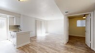 Located in Austin's vibrant 78704 neighborhood, this 2-bedroom, 1-bathroom unit is thoughtfully designed to maximize functionality across its single-floor layout. Light-toned wood-look flooring runs throughout, creating a bright and cohesive aesthetic from room to room.

The open-concept kitchen and living area serves as the heart of the unit. The kitchen features white shaker-style cabinetry, quartz countertops, a subway tile backsplash, stainless steel appliances including a refrigerator, electric range, and microwave, as well as a peninsula with an undermount sink that opens into the living space. Natural light pours in through a window at the end of the galley-style kitchen. The living room is generously sized with a sliding glass door fitted with vertical blinds that leads to a private patio.

Both bedrooms offer wood-look flooring and ceiling fans with light fixtures. The primary bedroom includes a walk-in closet, while additional closet storage is distributed throughout the unit. The full bathroom is finished with a white vanity, quartz countertop, wood-toned tile in the shower surround, and durable flooring. Completing the layout are a hallway, in-unit laundry area, and a pantry for added convenience.