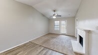 Located at 1135 Silverwood Dr in Arlington, Texas, this single-story, 2-bedroom, 2-bathroom home offers a well-designed layout with a comfortable mix of materials and finishes throughout. The living area makes a strong first impression with soaring vaulted ceilings, a ceiling fan with light kit, and a white brick fireplace that anchors the room. Wood-look plank flooring runs through the main living and dining areas, while plush carpet adds warmth to the bedrooms. Natural light filters in through windowed doors that open to the exterior, complemented by a chandelier in the dining area. The kitchen connects seamlessly to the living space with a pass-through opening. Both bathrooms are well-appointed, featuring granite countertops with undermount sinks, framed mirrors, and tiled tub-shower surrounds with marble-style tile. The primary bedroom is generously sized, featuring a ceiling fan, carpet, and direct access to a dedicated bathroom. The second bedroom also includes carpet, a ceiling fan, a window for natural light, and its own closet. Each bedroom benefits from dedicated closet space, with the primary featuring a walk-in closet. A laundry area rounds out the functional layout of this move-in-ready home.