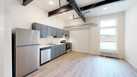 Step into a world of possibilities in this expertly designed 430 square foot studio, where every inch has been thoughtfully curated to maximize both style and function. As you enter, you're greeted by the warm glow of natural light streaming through expansive windows, illuminating the gleaming wood-look floors that flow seamlessly throughout the space.

The heart of this urban oasis is the stunning kitchen, a chef's dream come true. Sleek gray cabinetry stretches from floor to ceiling, providing ample storage and creating a sense of height and spaciousness. Stainless steel appliances, including a full-sized refrigerator and range, stand ready to bring your culinary visions to life. The clean lines and modern finishes create an atmosphere of sophistication that will inspire your inner gourmet.

The bathroom is a serene retreat, featuring a contemporary vanity with ample counter space and storage. The crisp white palette and stylish fixtures evoke a spa-like ambiance, offering a tranquil start and end to each day.

Exposed beams and industrial-chic ductwork add character and visual interest to the soaring ceilings, creating a loft-like atmosphere that's both trendy and timeless. This flexible, open-concept layout allows you to define spaces that suit your unique lifestyle, whether you're working from home, entertaining friends, or simply relaxing after a long day.

Located in the heart of Olympia, this studio isn't just a home—it's a launchpad for the life you've always dreamed of. Embrace the vibrant city culture, explore local cafes and boutiques, and immerse yourself in the rich history and natural beauty of the Pacific Northwest. Your adventure begins here, in this perfectly appointed urban sanctuary.