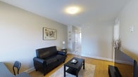 This two-bedroom, two-bathroom residence is thoughtfully laid out across a single floor, offering a cohesive and efficient use of space. The living area serves as the heart of the home, featuring warm hardwood flooring that extends throughout, clean white walls, and soft neutral tones that create a calm and welcoming atmosphere. Flush ceiling lighting provides even illumination, complementing the understated yet functional design aesthetic. The living room offers comfortable space for relaxing or entertaining, with a hallway leading seamlessly to the rest of the home. The layout connects the main living areas in a logical and practical flow, making everyday movement through the space easy and intuitive. The interior design is characterized by its simplicity and clean lines, with light-toned walls and white trim that enhance the sense of openness. The two bedrooms provide private retreats, while the two full bathrooms add convenience for residents and guests alike. Overall, this home strikes a balance between comfort and practicality, making it a well-rounded and livable space suited for a variety of lifestyles.