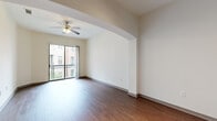 Located at 3616 Richmond Ave in Houston's vibrant 77046 corridor, this one-bedroom, one-bathroom residence offers a thoughtfully designed single-story layout with a range of functional and aesthetic features. The living room is highlighted by soaring ceilings, rich hardwood-style flooring, a ceiling fan, and a sliding glass door that opens to a private balcony with outdoor views, flooding the space with natural light. Elegant arched doorways connect the living area to the kitchen and hallways, adding architectural character throughout. A decorative arched niche with a display ledge serves as a charming design accent near the kitchen entry. The kitchen is well-appointed with dark espresso cabinetry, granite-style countertops, tile flooring, and stainless steel appliances including a range and over-the-range microwave. The spacious primary bedroom features plush carpeting, high ceilings, a ceiling fan, and direct access to a dedicated closet. The full bathroom includes a dark wood vanity with granite countertop, overhead cabinetry, a large mirror, and a tiled shower-tub combination. A dedicated in-unit laundry room with tile flooring and built-in shelving completes this well-appointed residence.