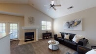 Located at 7010 W 124th St in Overland Park, Kansas, this single-floor home offers a well-designed layout with a blend of comfortable living spaces and functional features throughout.

The living room serves as the heart of the home, showcasing soaring vaulted ceilings and a ceiling fan that enhance the sense of openness. A tile-surround fireplace with a classic white mantel anchors the room, while a large window invites natural light and views of the outdoors. Plush carpeting and neutral-toned walls create a warm, inviting atmosphere.

The kitchen is efficiently laid out with rich, warm-toned cabinetry that provides generous storage. It features white appliances including a range, over-the-range microwave, refrigerator, and dishwasher. Durable hardwood-style flooring runs underfoot, and a pass-through or bar area connects the kitchen to the adjacent living space, promoting an open, social feel.

The bedroom is a serene retreat, finished with soft carpet, warm neutral walls, a ceiling fan, and a sizable window that fills the room with natural light and outdoor views.

The bathroom is clean and well-appointed, offering a full tub-and-shower combination with tiled surround, a wide vanity with ample counter space, a large mirror, and hardwood-style flooring, completing this comfortable and move-in-ready home.