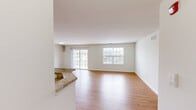 Located at 1 Rosewood Ave in Springfield, NJ, this well-appointed 2-bedroom, 2-bathroom single-floor residence offers a thoughtfully designed layout with modern finishes throughout. The open-concept living and dining area is bright and airy, featuring warm hardwood-style flooring, crisp white walls, and multiple windows including a sliding glass door that floods the space with natural light and provides outdoor access. The kitchen is a standout, showcasing rich dark wood cabinetry, granite countertops, a stainless steel sink, and a full suite of stainless steel appliances including a gas range, built-in microwave, and refrigerator, all set atop clean tile flooring. The generously sized primary bedroom offers ample space and its own dedicated closet. The second bedroom also features hardwood-style floors and a large window with natural light. Both bathrooms are finished with granite vanity tops, white cabinetry, and tile flooring; the primary bath includes a glass-enclosed shower and tub combination. Additional highlights include two closets for storage and an in-unit washer and dryer. The clean, neutral palette and consistent finishes create a cohesive, move-in-ready ambiance throughout the home.