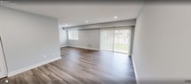 This well-designed apartment in Fairfax, VA, maximizes its 660 square feet with a thoughtful layout. The space includes two bedrooms, one bathroom, a kitchen, and a living room, all on a single floor. The primary bedroom is generously sized at 180 square feet, providing ample space for comfortable living.

The apartment boasts modern finishes throughout, with a cohesive design aesthetic. Light-colored walls and recessed lighting create a bright, airy atmosphere. The living area features sleek wood-look flooring and a large sliding glass door, offering views of the outdoor space and allowing natural light to flood the room.

The kitchen is efficiently designed with dark cabinets contrasting beautifully against light granite countertops. Stainless steel appliances and ample storage space make it both functional and visually appealing. The bathroom continues the modern theme with a dark wood vanity, granite countertop, and a striped shower curtain adding a touch of nautical charm.

Both bedrooms are well-lit, with one featuring plush carpeting and the other continuing the wood-look flooring. Built-in closets with adjustable shelving systems provide excellent storage solutions. The overall design prioritizes space efficiency while maintaining a contemporary and inviting ambiance.