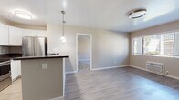 Located at 1379 27th St in San Diego, CA, this single-story residence offers a clean, modern interior with a thoughtfully designed open-concept layout. The living area flows seamlessly from the kitchen, finished with light wood-look flooring throughout and neutral warm-toned walls that create a bright, welcoming atmosphere. Natural light filters in through window blinds, enhancing the airy feel of the main living spaces.

The kitchen is well-appointed with white cabinetry, dark countertops, and a full suite of stainless steel appliances including a French door refrigerator, electric range, built-in microwave, and dishwasher. A peninsula with pendant lighting serves as both a functional workspace and a casual dining area. A ceiling fan overhead adds comfort to the adjoining living space.

The bedrooms feature plush carpeting, ceiling fans, and windows with blinds that allow for natural light and privacy. Each room offers generous proportions suitable for comfortable furnishing arrangements.

The bathrooms are finished with white cabinetry, dark countertops, and full tub-shower combinations with brushed nickel fixtures. Tile flooring and clean, neutral finishes complete the functional and tidy design. Overall, this residence presents a well-maintained, move-in-ready interior with consistent finishes throughout.